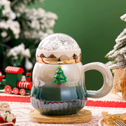 Handheld Christmas snow globe mugs in red and green for gifting
